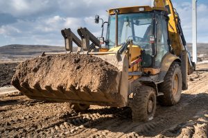 Close up details of industrial backhoe loader, details of machinery on construction site