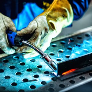 Welder with protective mask welding metal